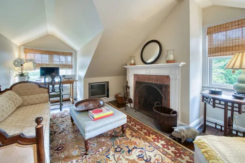 a living room with furniture a fireplace and a table