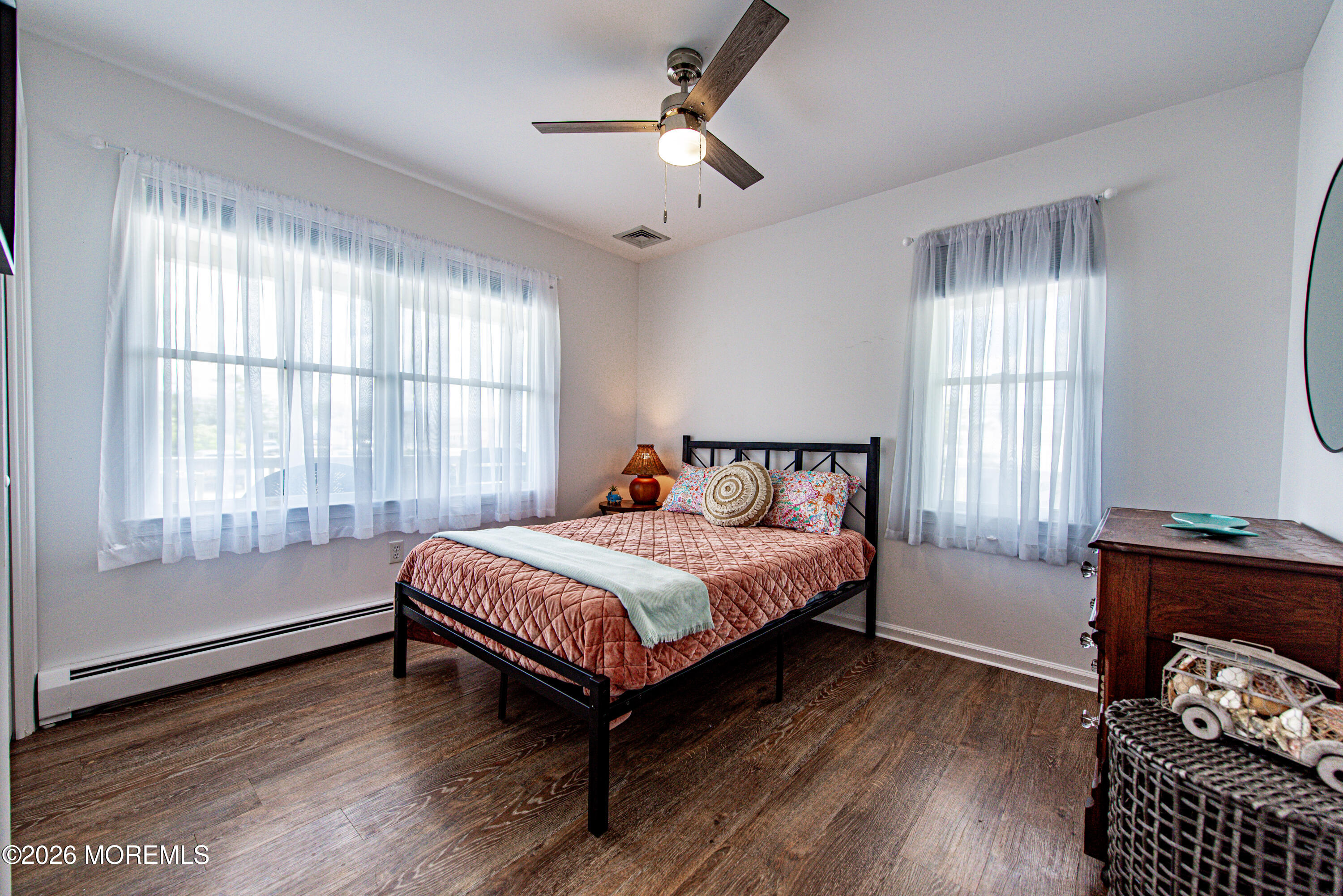 5 A Sunset Boulevard Barnegat Light, NJ 08006 - Photo 29 of 65 a spacious bedroom with a bed and wooden floor