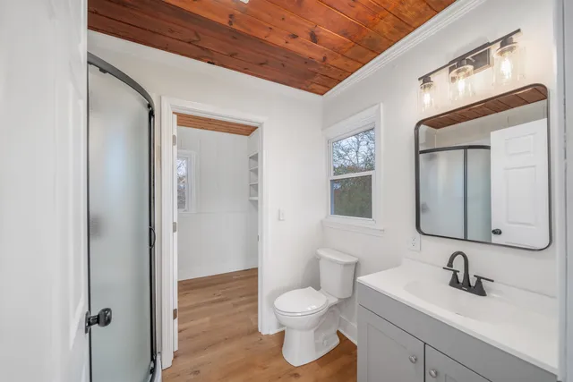 a bathroom with a toilet a sink and mirror
