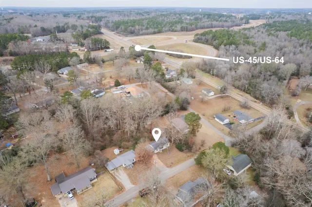 an aerial view of a house with a yard