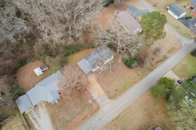 an aerial view of a house with a yard
