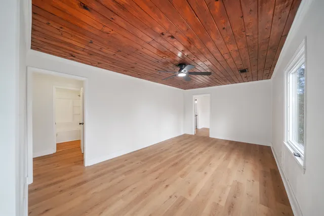 a view of empty room with wooden floor