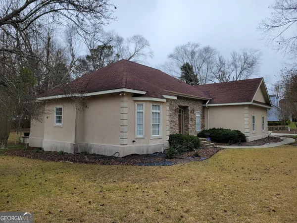 a kitchen with a sink and wooden floor