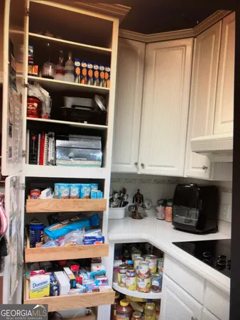 a white house that has a tree in front of it