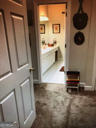 a kitchen with cabinets and chairs