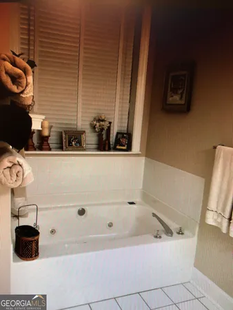 a bedroom with a bed dresser and a window