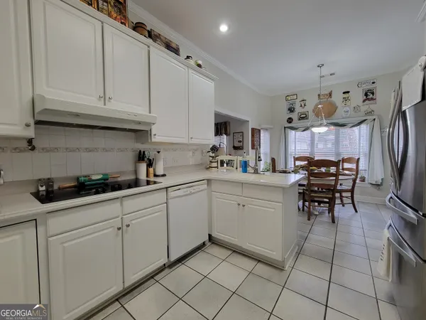 a bedroom with a bed and a flat tv screen on the dresser