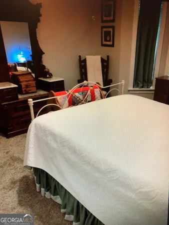 a bedroom with a bed and a table in it