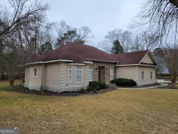 a front view of a house with garden