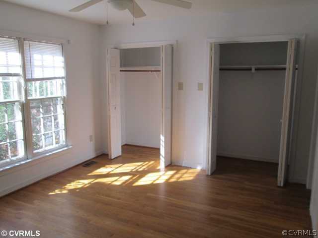 5805 Mill Spring Road Midlothian, VA 23112 - Photo 4 of 8 an empty room with wooden floor closet and windows