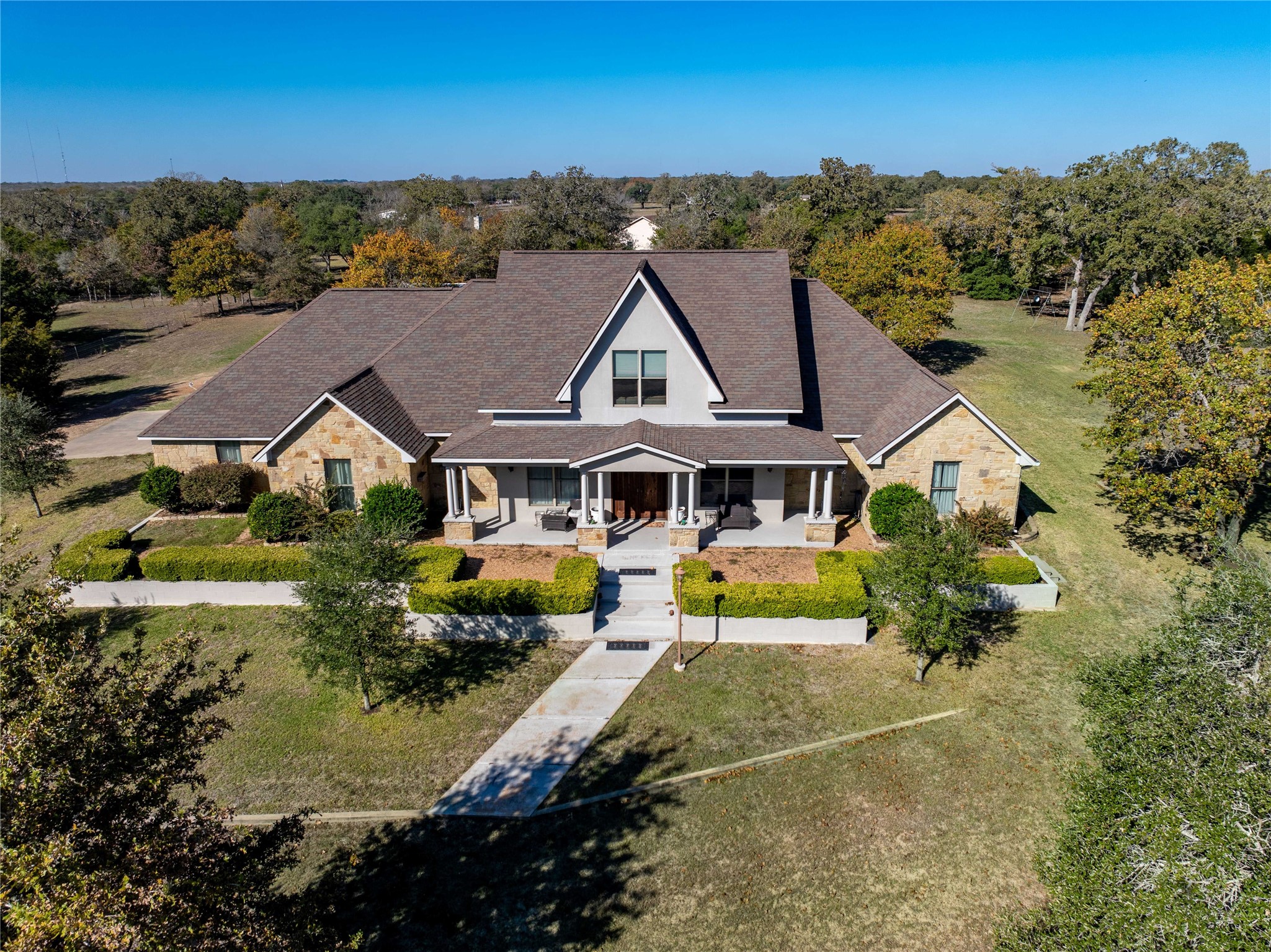 a front view of house with yard and green space