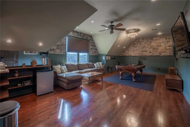 a living room with furniture and kitchen view