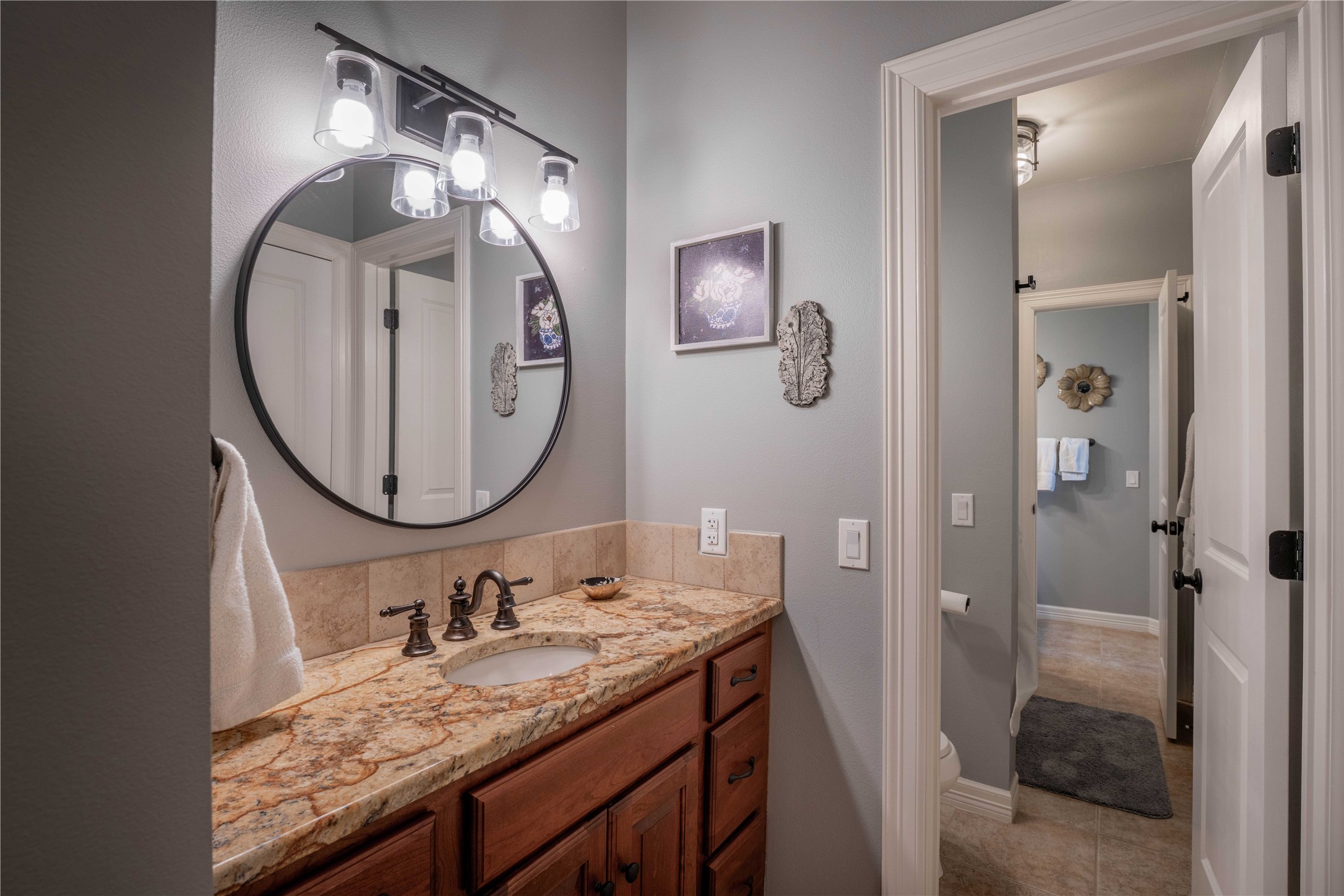 1820 Guenther Road La Grange, TX 78945 - Photo 15 of 29 a bathroom with a granite countertop sink mirror and vanity
