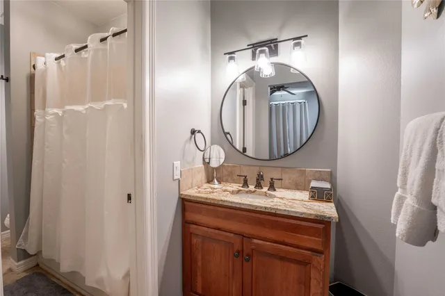 a bathroom with a sink vanity mirror and a mirror