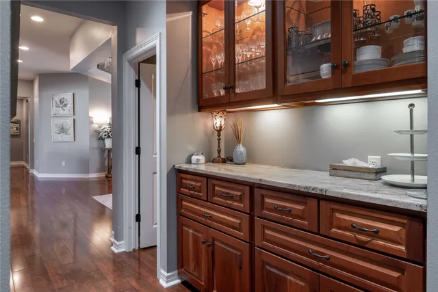 a kitchen with a refrigerator and wooden floor