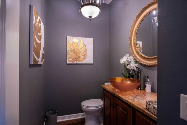 a bathroom with a toilet and a mirror