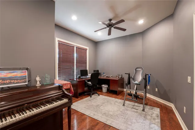 a living room with furniture and a piano