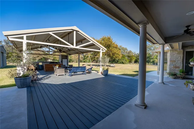 a view of a deck with wooden floor and furniture