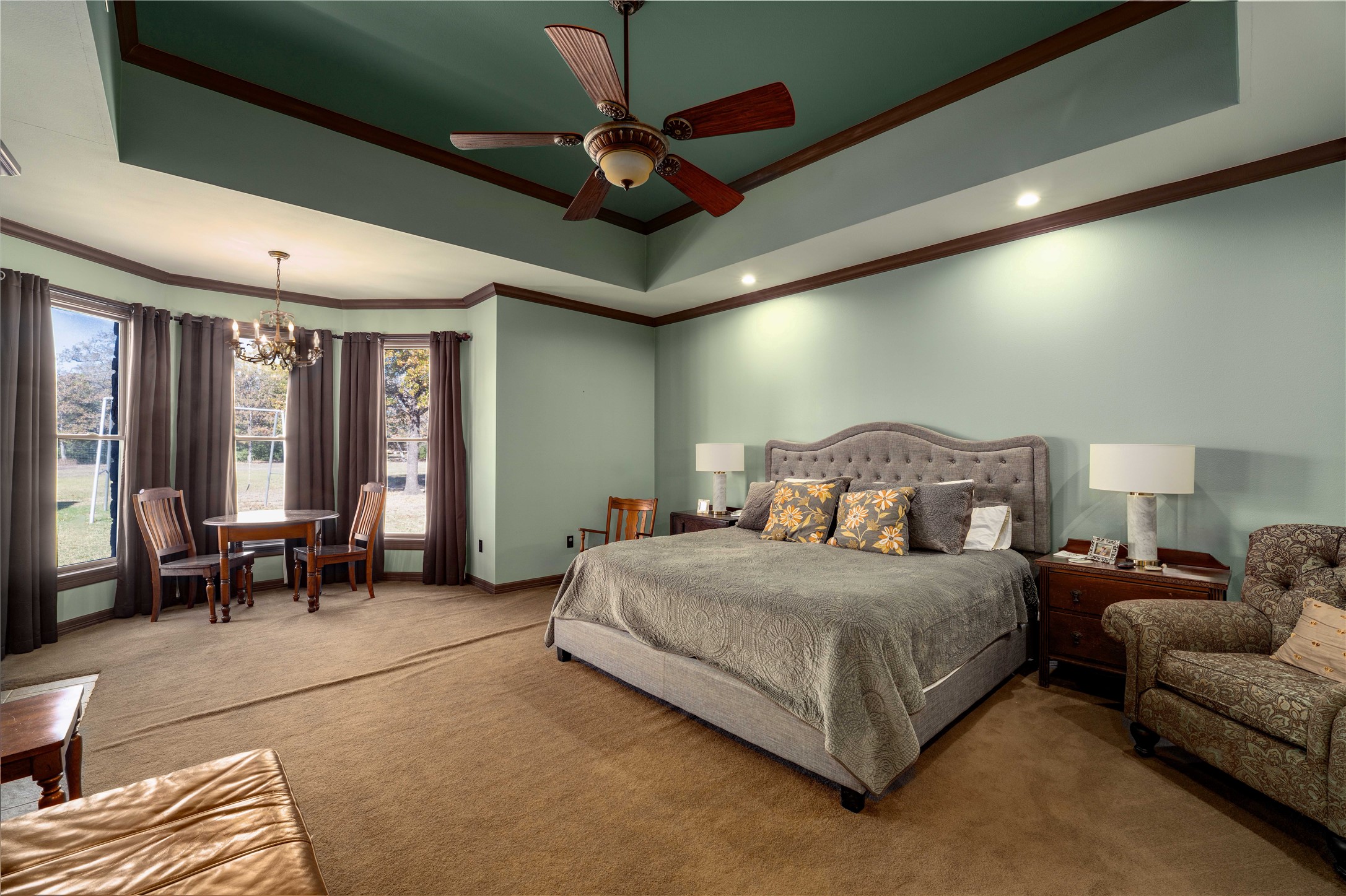 1820 Guenther Road La Grange, TX 78945 - Photo 10 of 29 a spacious bedroom with a bed and a chandelier