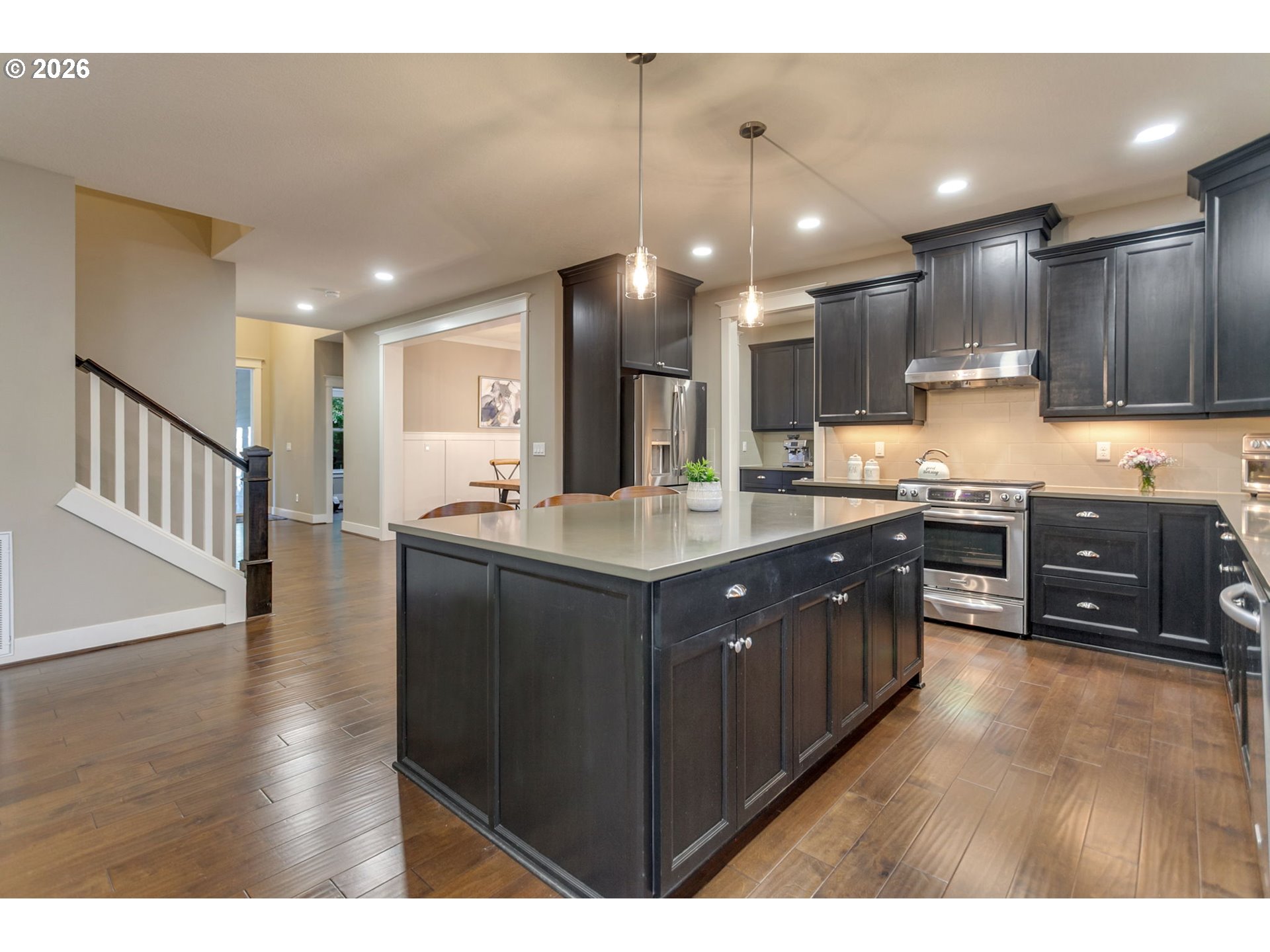 14390 Southwest Fox Lane Beaverton, OR 97008 - Photo 32 of 47 a kitchen with wooden cabinets and center island
