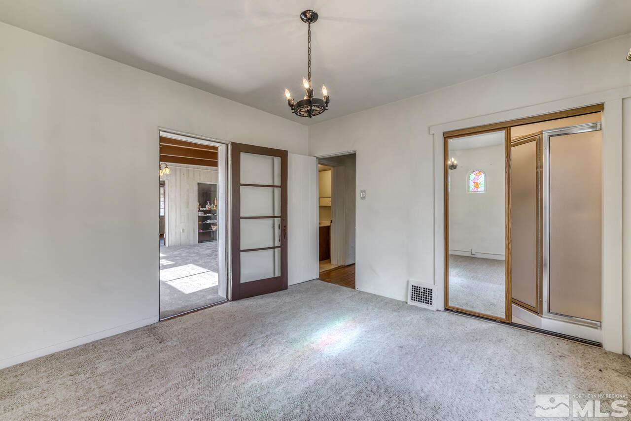 160 Circle Drive Reno, NV 89509 - Photo 18 of 25 an empty room with chandelier fan and windows
