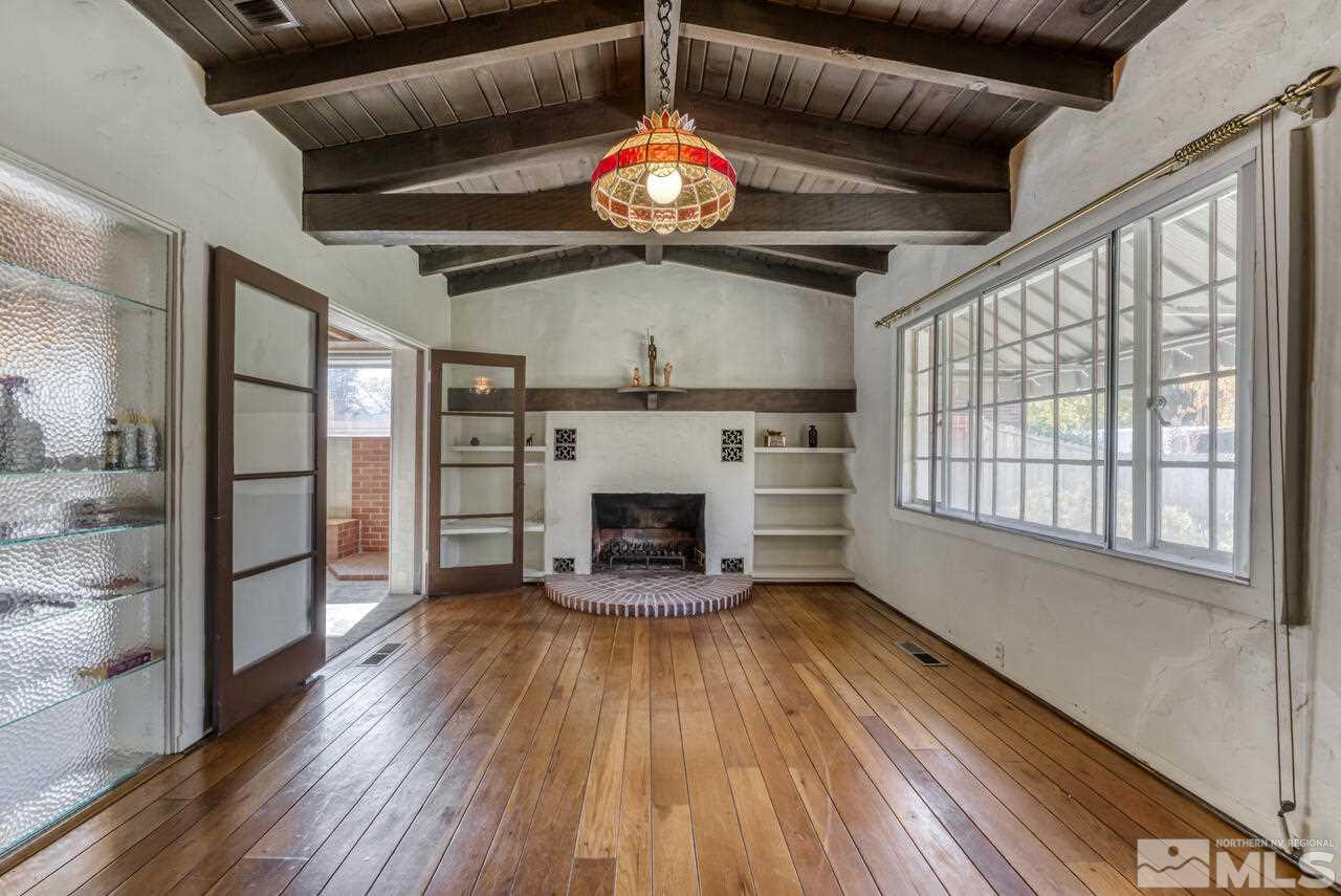 160 Circle Drive Reno, NV 89509 - Photo 5 of 25 a view of an empty room with wooden floor fireplace and a window