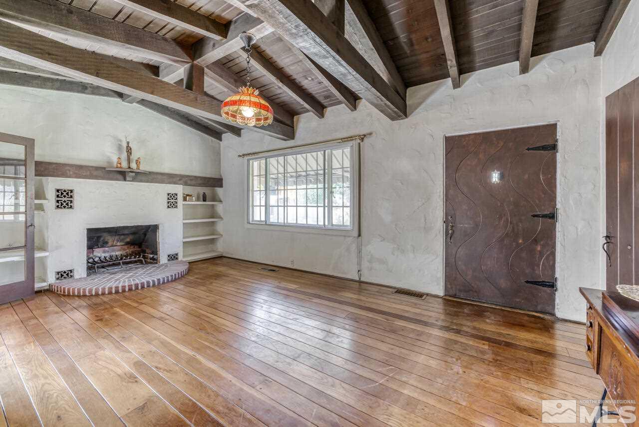 160 Circle Drive Reno, NV 89509 - Photo 6 of 25 a view of an empty room with wooden floor fireplace and a window