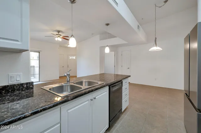 a kitchen with white cabinets and appliances