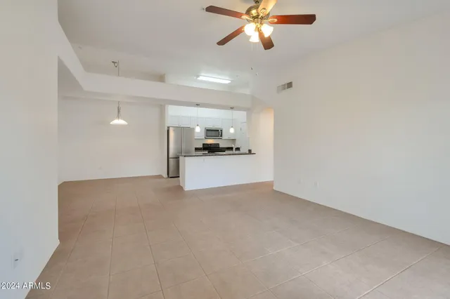 a view of a kitchen with a sink and chandelier fan