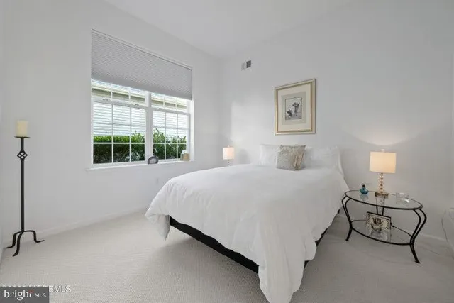 a bed sitting in a bedroom next to a window