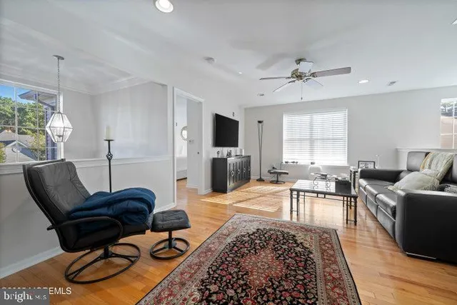 a living room with furniture a chandelier and a rug