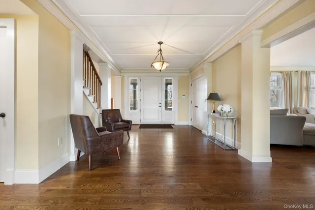 a view of a livingroom with furniture hardwood floor and a ceiling fan