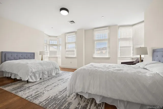 a bedroom with a large bed and a window
