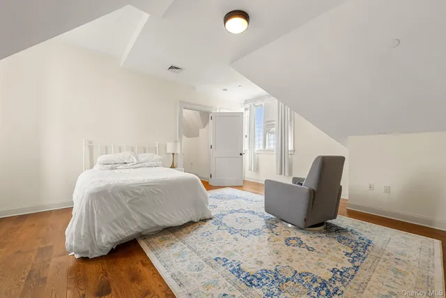 a bedroom with a bed and chair