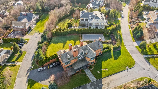 an aerial view of a house with swimming pool and outdoor seating