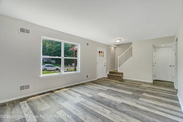 a bathroom with a granite countertop sink toilet and a mirror