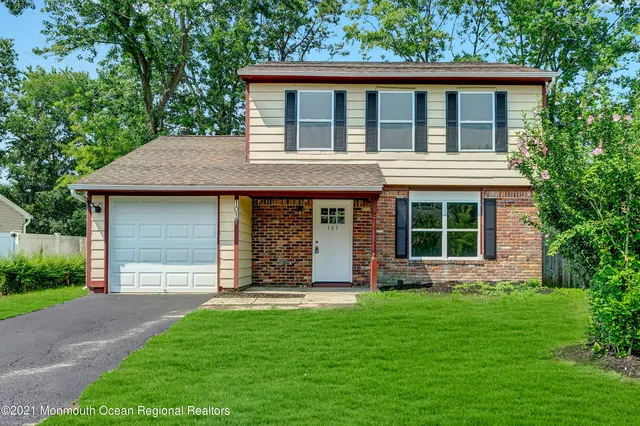 a view of house with backyard space and garden
