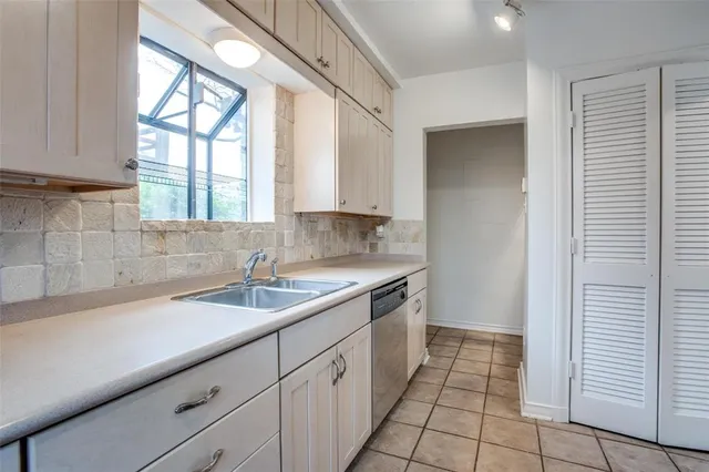 a kitchen with a sink and cabinets