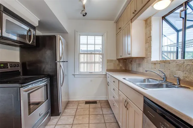 a kitchen with stainless steel appliances a stove sink and microwave