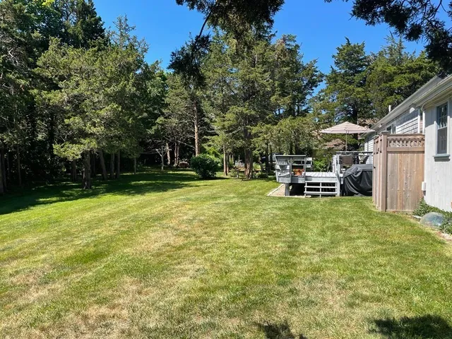 a view of a house with backyard and sitting area