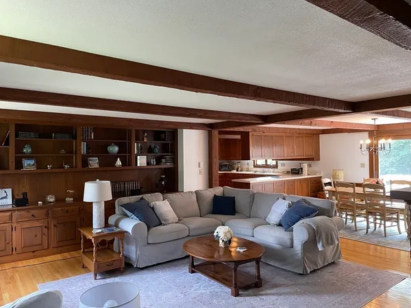 a living room with furniture and kitchen view