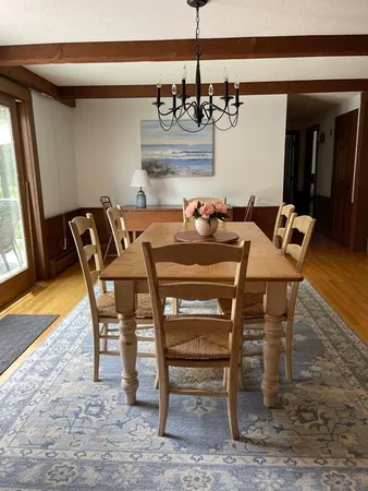 a view of a dining room with furniture and a chandelier