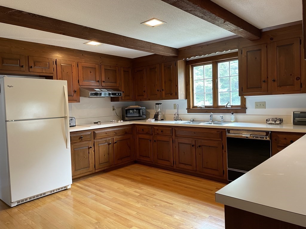 12 Seavers Road Orleans, MA 02653 - Photo 9 of 18 a kitchen with a sink a refrigerator and window