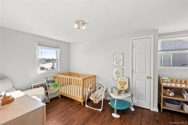a bedroom with furniture and a wooden floor