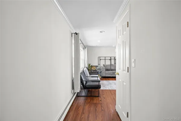 a hallway with a couch and wooden floor