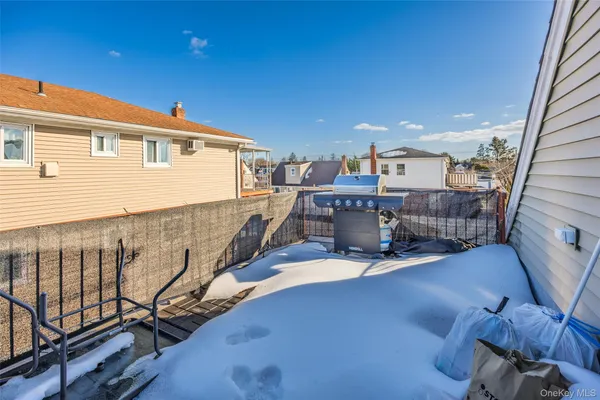 a balcony with table and chairs