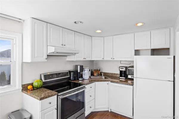 a kitchen with cabinets appliances and a counter top space
