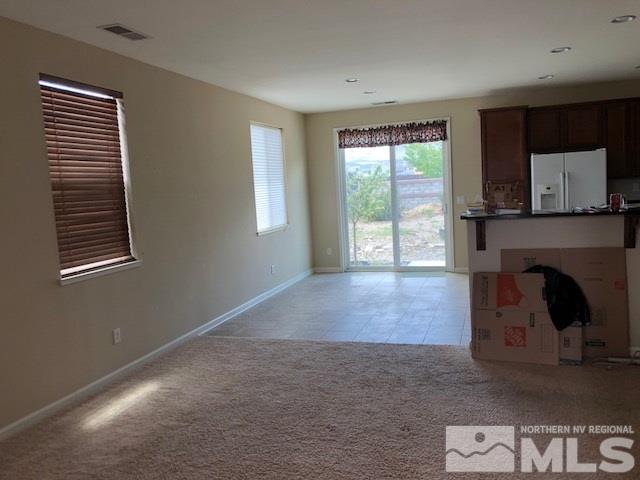 9193 Raytheon Court Reno, NV 89506 - Photo 2 of 11 a view of an empty room with a fireplace and a window