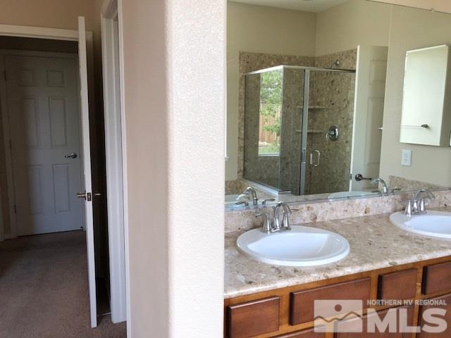 9193 Raytheon Court Reno, NV 89506 - Photo 5 of 11 a bathroom with sink granite and a mirror