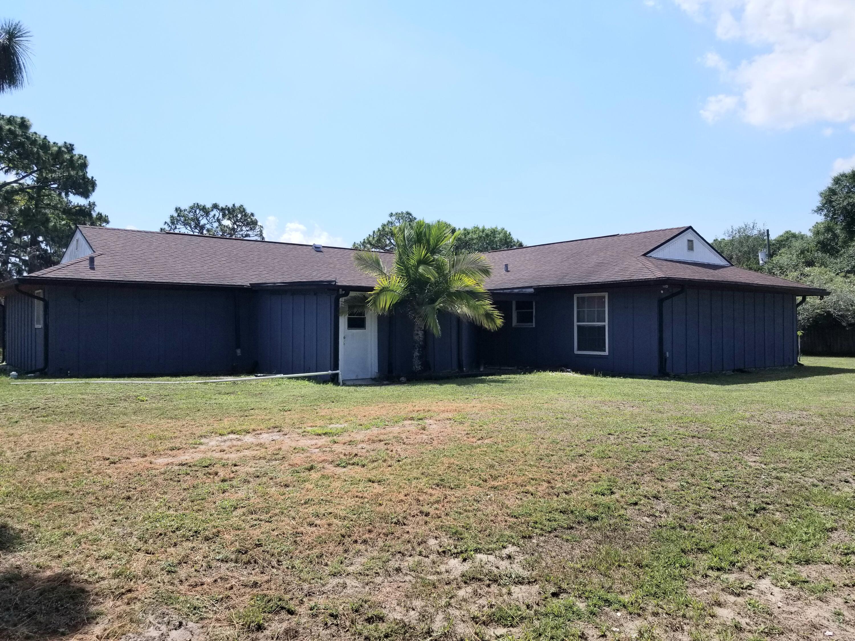 3700 Pine Cone Road Melbourne, FL 32934 - Photo 6 of 38 a house with a yard